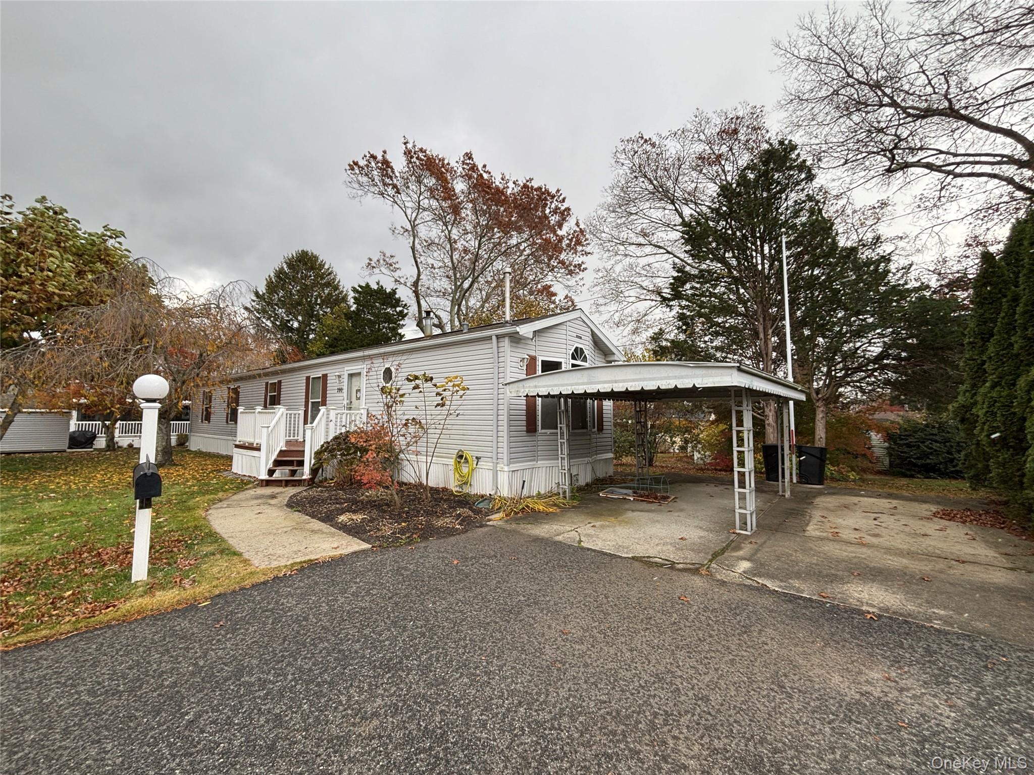 a view of a house with a large tree in front of it