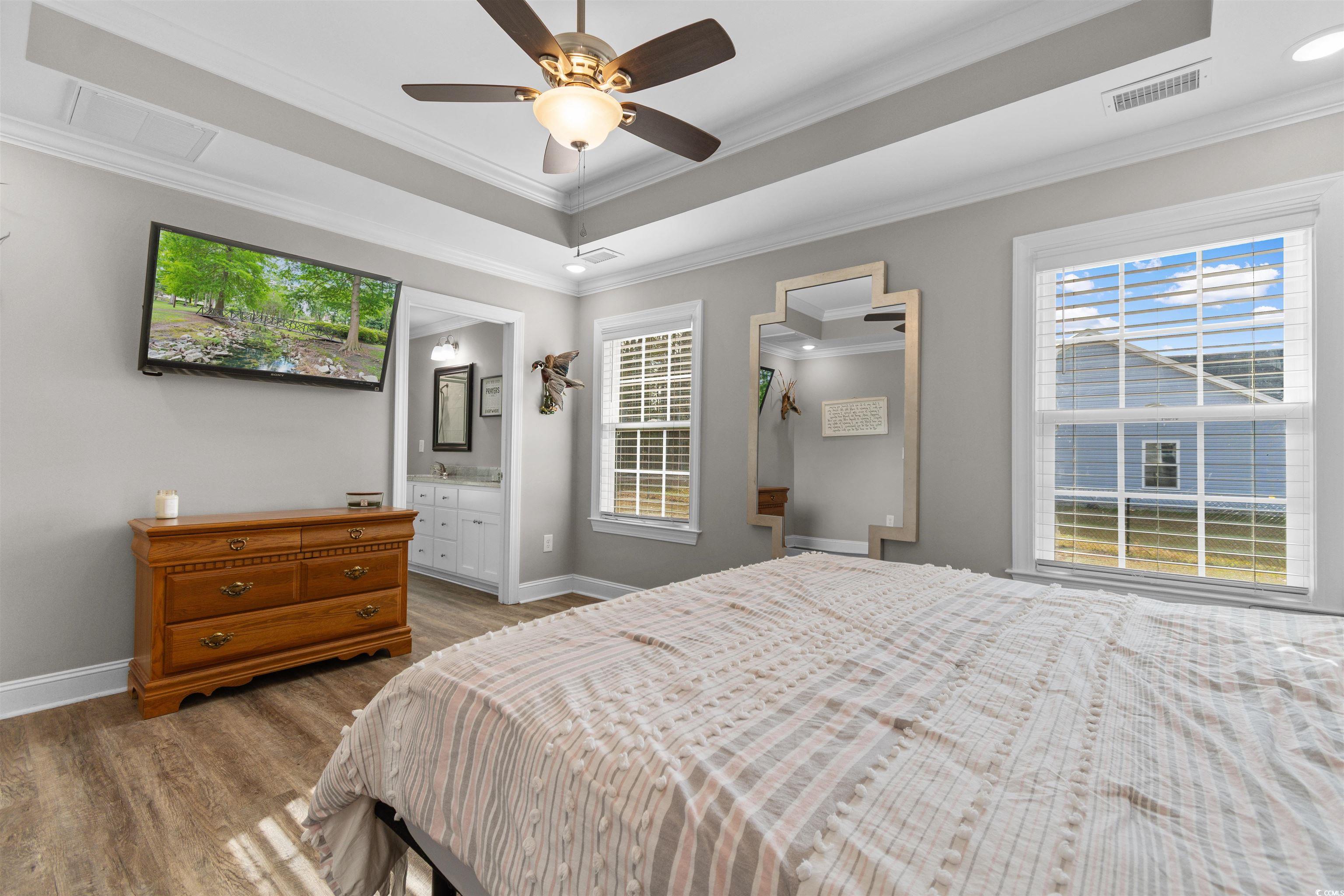 1275 Pinetucky Drive Galivants Ferry, SC 29544 - Photo 12 of 39 Bedroom with wood finished floors, multiple windows, crown molding, a ceiling fan, and a raised ceiling