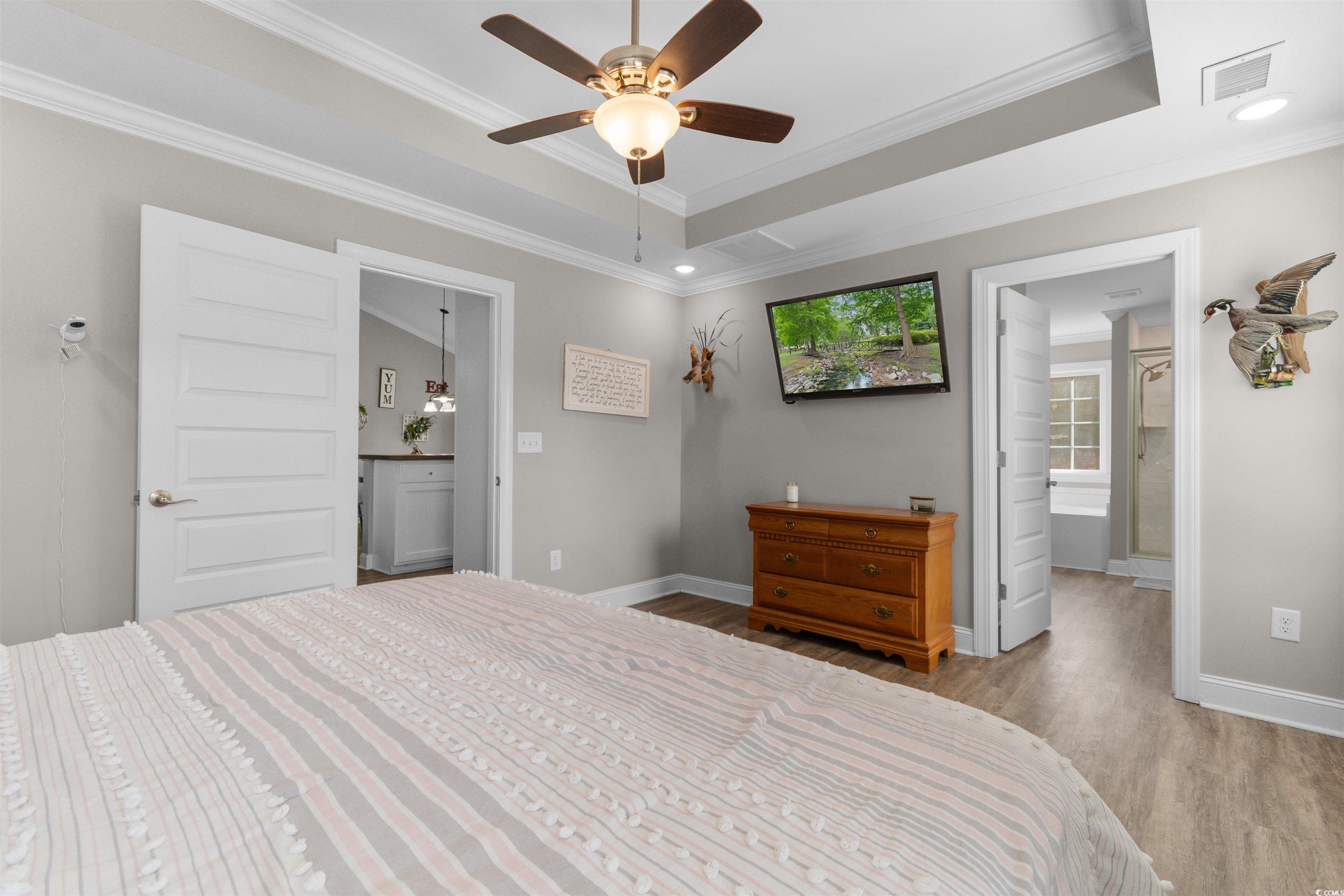 1275 Pinetucky Drive Galivants Ferry, SC 29544 - Photo 14 of 39 Bedroom featuring ensuite bath, a raised ceiling, wood finished floors, and ornamental molding