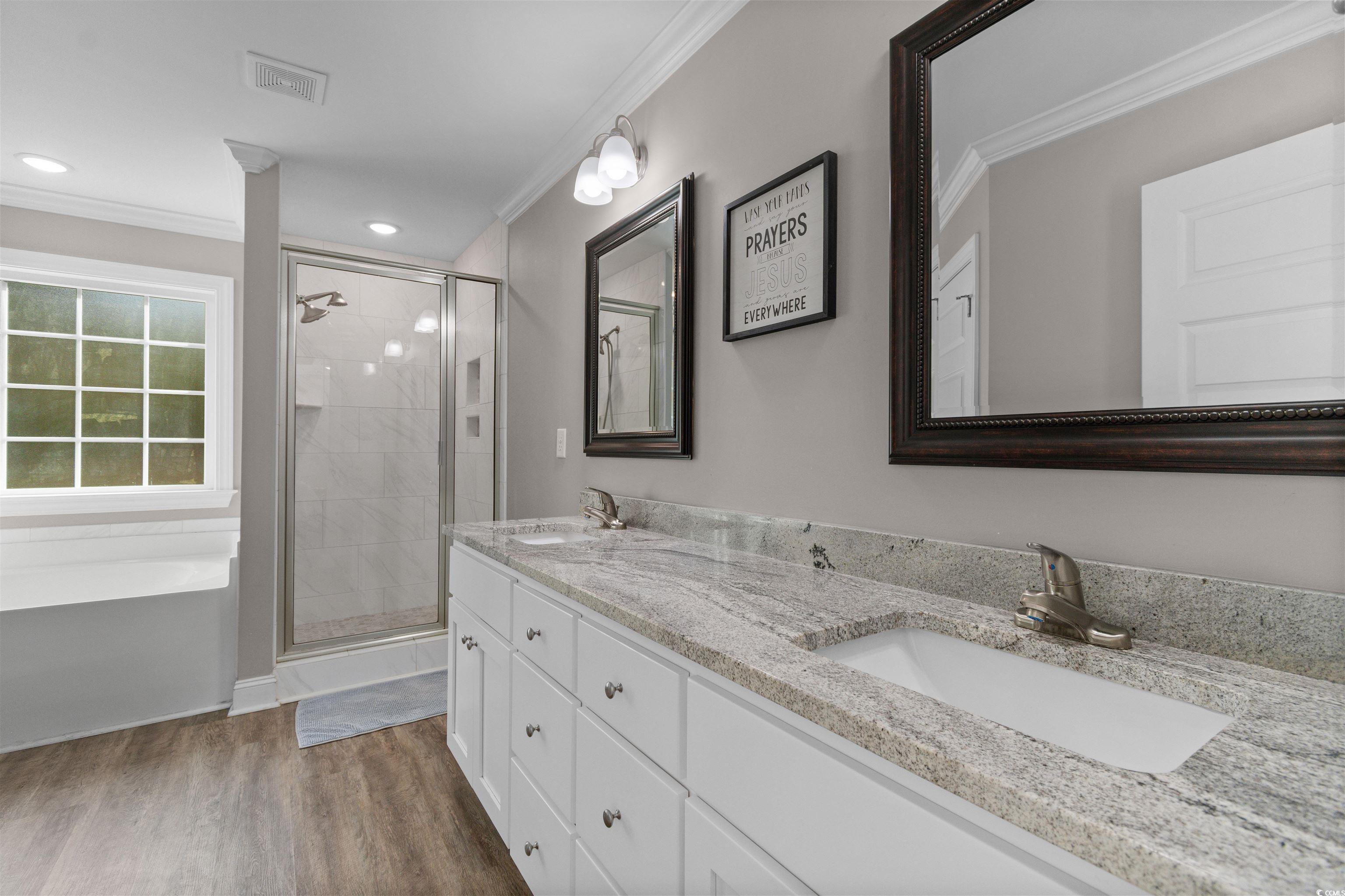 1275 Pinetucky Drive Galivants Ferry, SC 29544 - Photo 15 of 39 Bathroom featuring double vanity, light wood-type flooring, crown molding, a shower stall, and recessed lighting