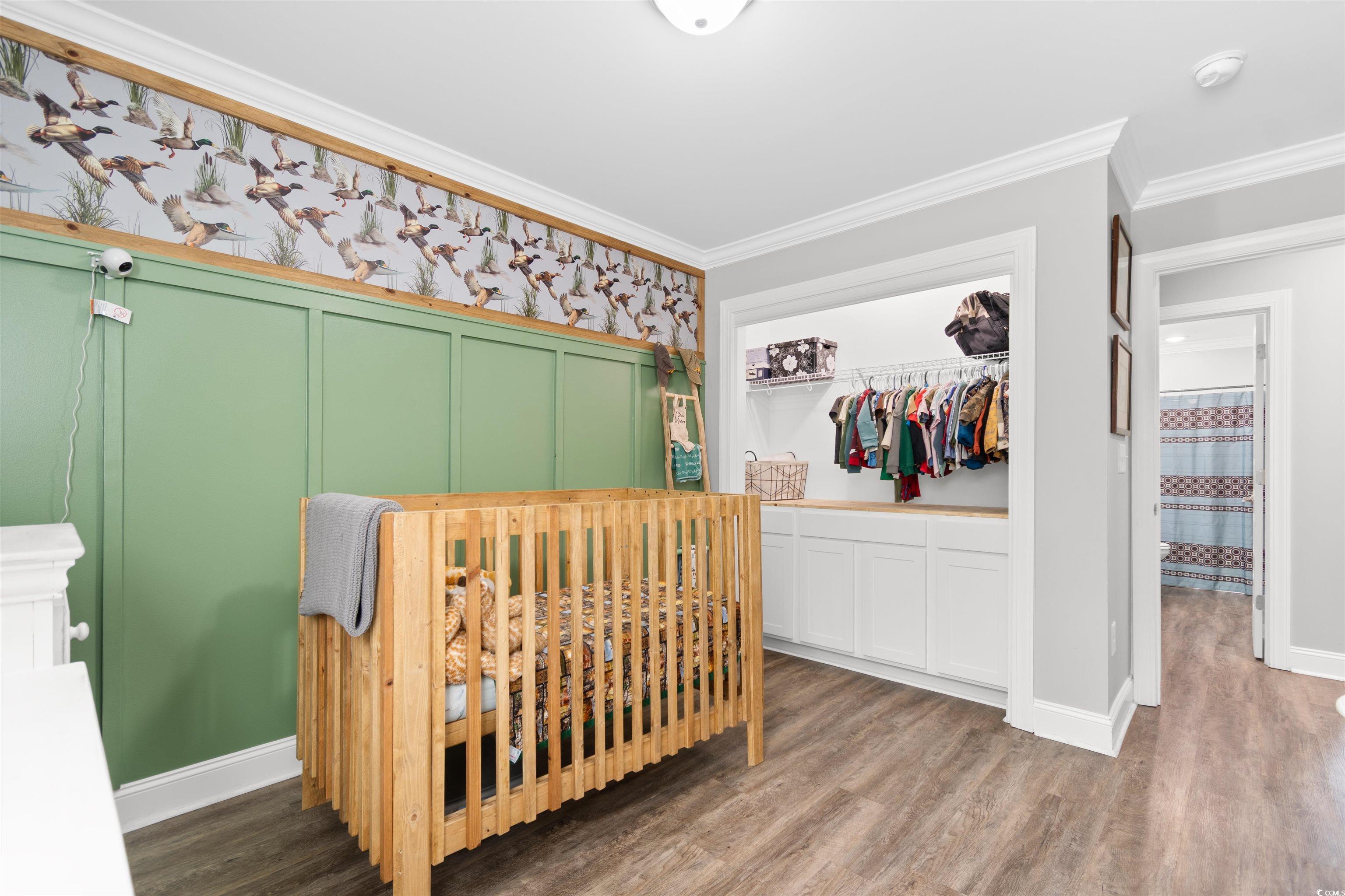 1275 Pinetucky Drive Galivants Ferry, SC 29544 - Photo 18 of 39 Bedroom featuring a closet, wood finished floors, ornamental molding, and wallpapered walls