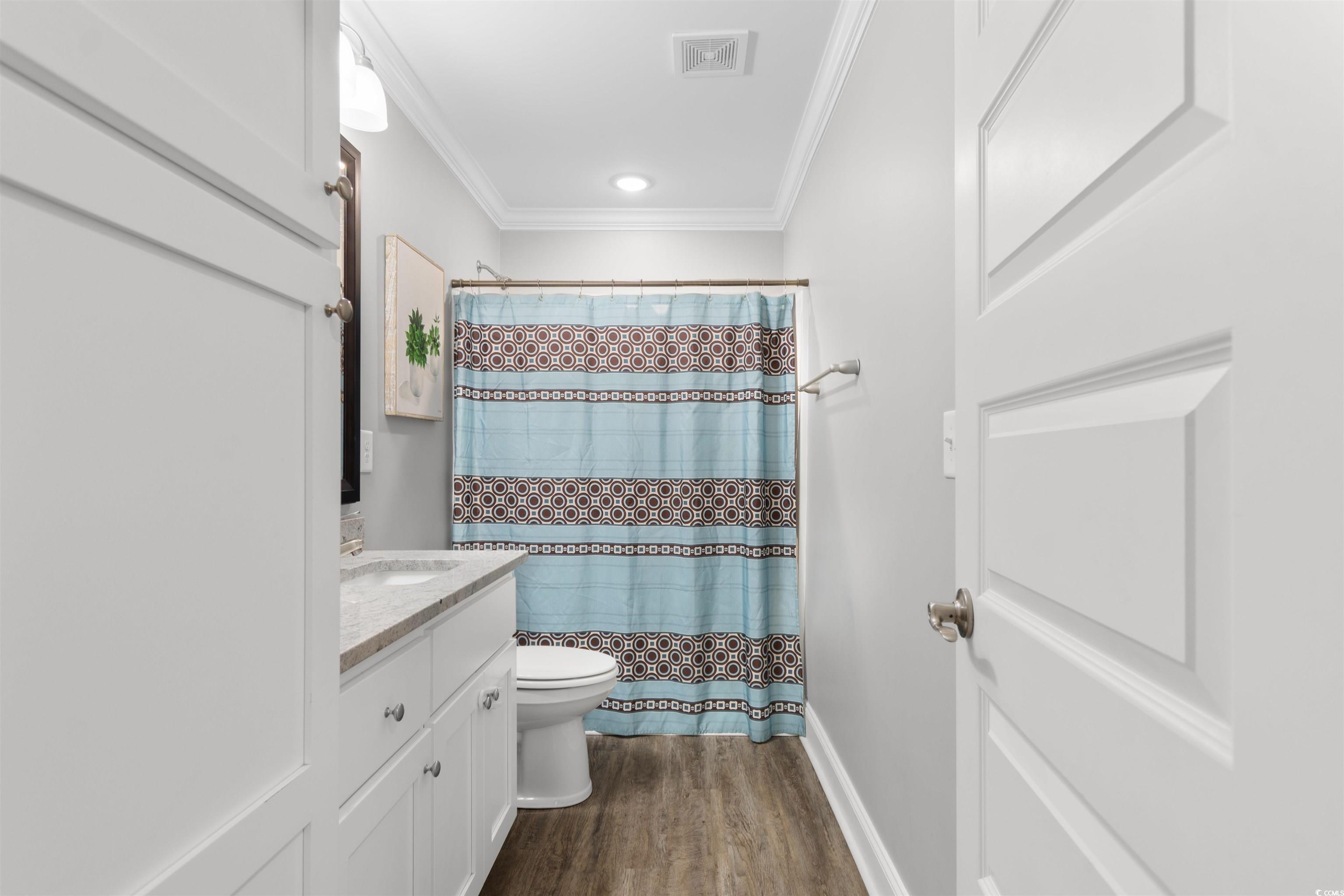 1275 Pinetucky Drive Galivants Ferry, SC 29544 - Photo 20 of 39 Full bath featuring a shower with curtain, crown molding, dark wood-type flooring, and vanity
