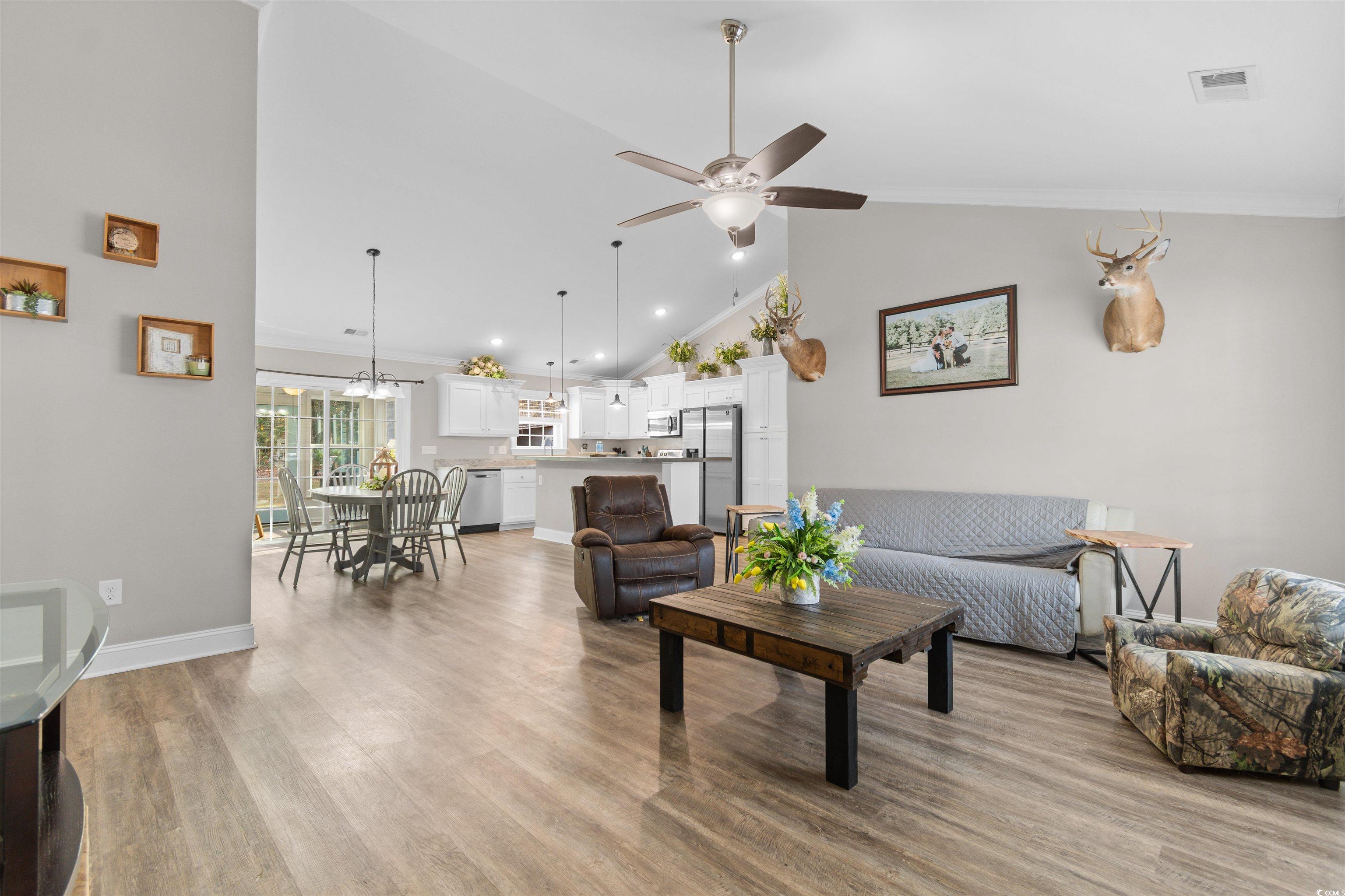 1275 Pinetucky Drive Galivants Ferry, SC 29544 - Photo 2 of 39 Living room with high vaulted ceiling, a ceiling fan, light wood-style flooring, and ornamental molding