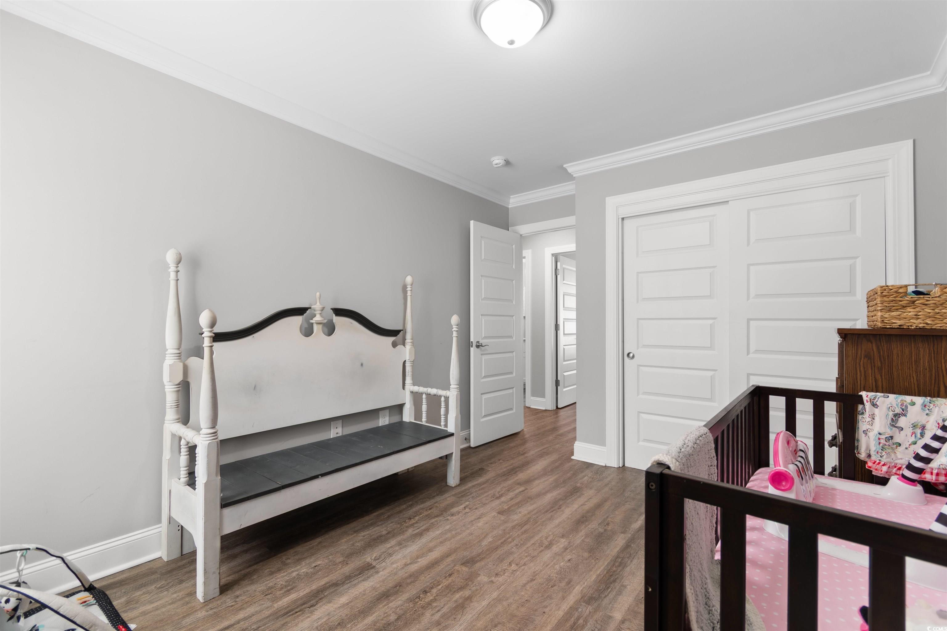 1275 Pinetucky Drive Galivants Ferry, SC 29544 - Photo 25 of 39 Bedroom featuring a closet, crown molding, and wood finished floors