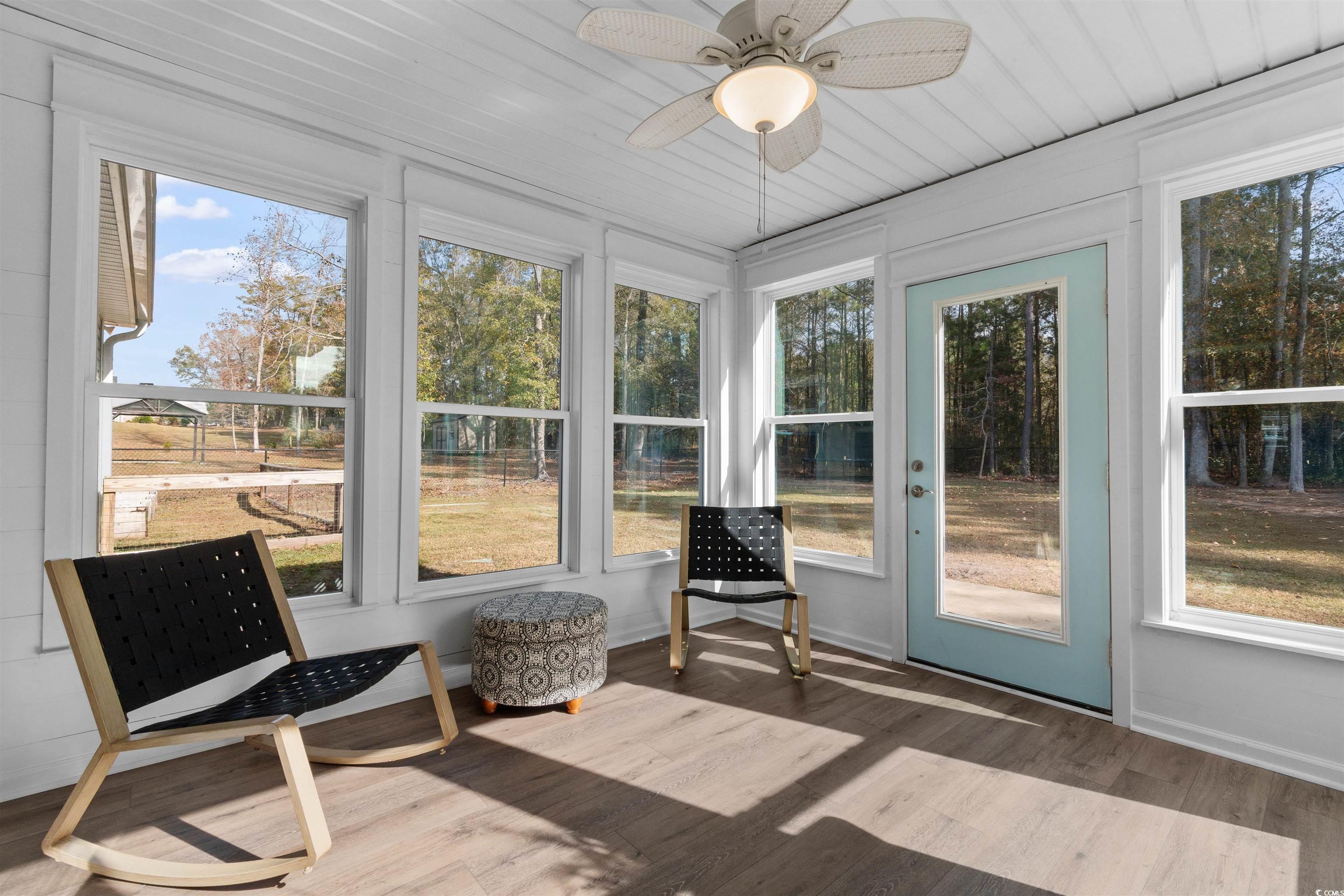 1275 Pinetucky Drive Galivants Ferry, SC 29544 - Photo 27 of 39 Sunroom / solarium featuring a ceiling fan, wood finished floors, and plenty of natural light