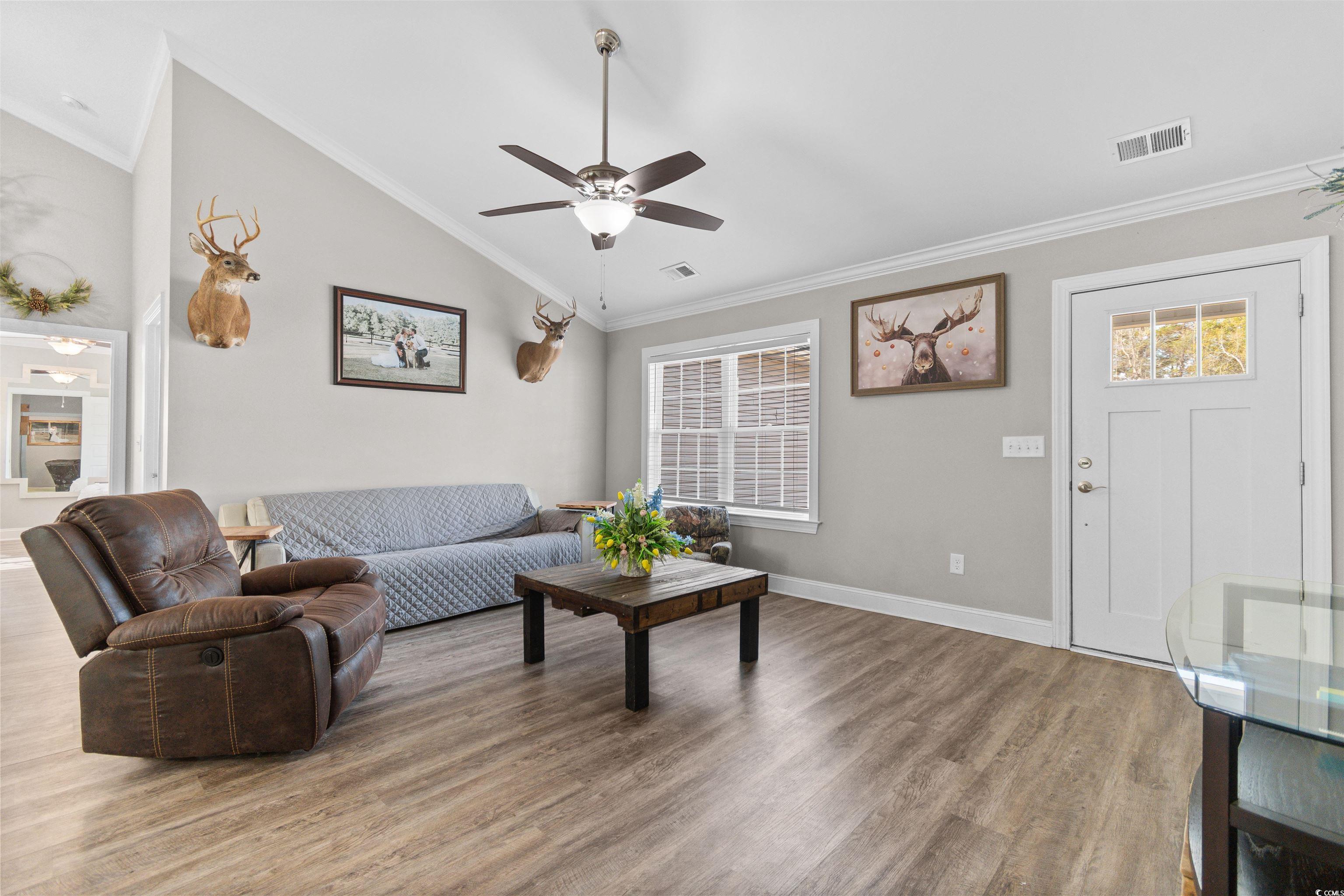 1275 Pinetucky Drive Galivants Ferry, SC 29544 - Photo 3 of 39 Living room featuring crown molding, vaulted ceiling, ceiling fan, and light wood-type flooring
