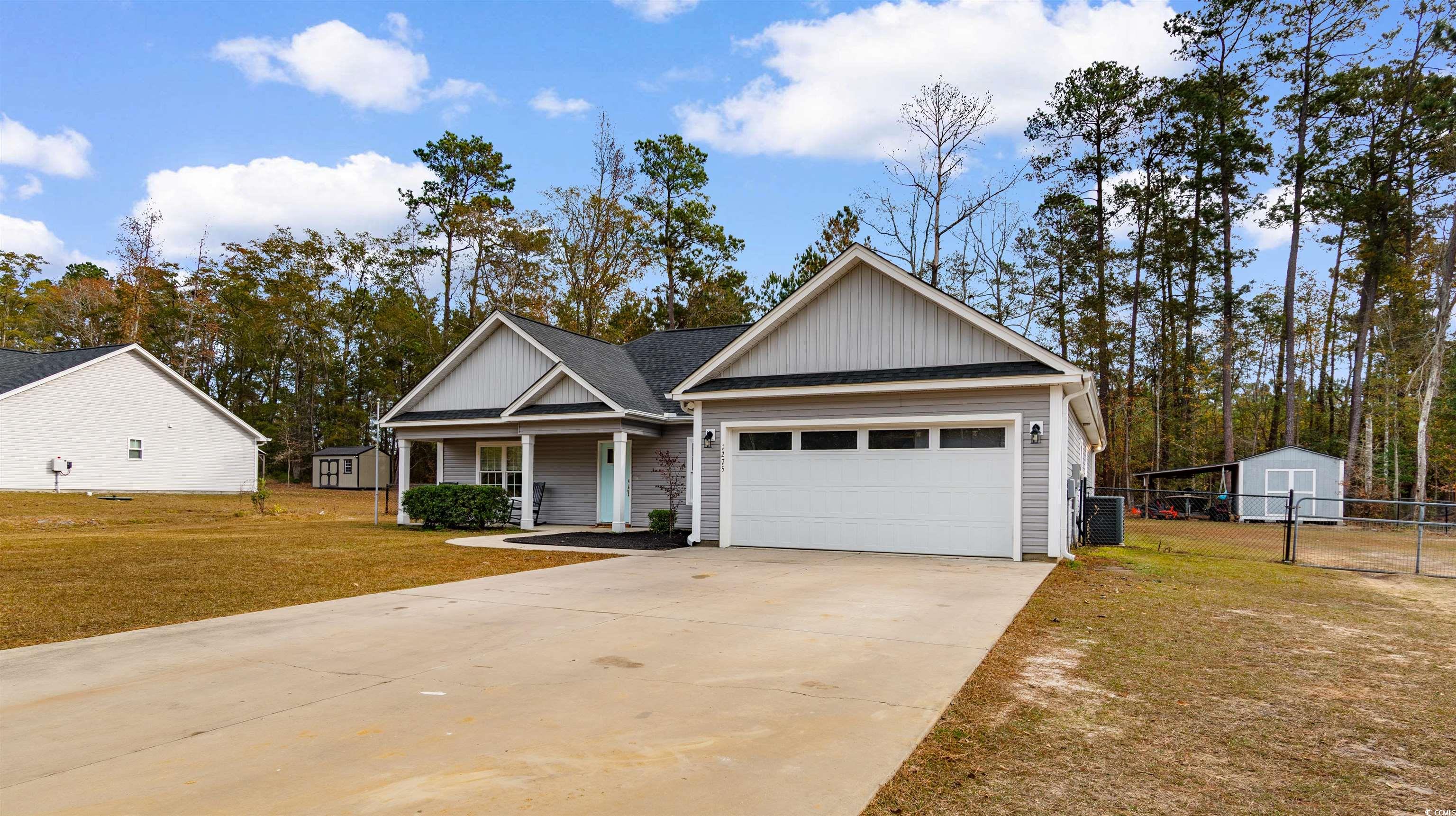 1275 Pinetucky Drive Galivants Ferry, SC 29544 - Photo 39 of 39 View of front of home featuring a porch, concrete driveway, board and batten siding, and a shed