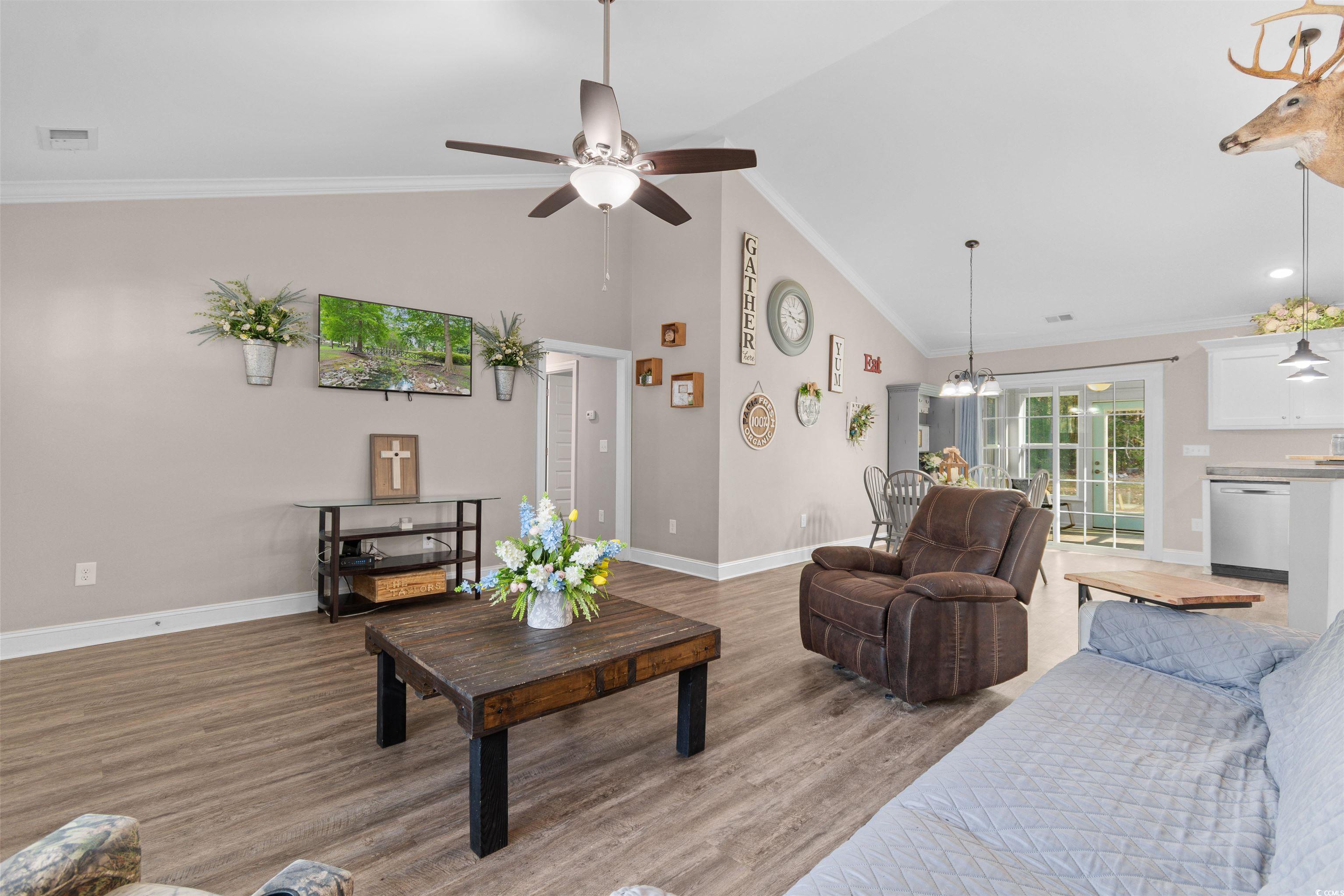 1275 Pinetucky Drive Galivants Ferry, SC 29544 - Photo 4 of 39 Living area with crown molding, light wood-style floors, high vaulted ceiling, and ceiling fan