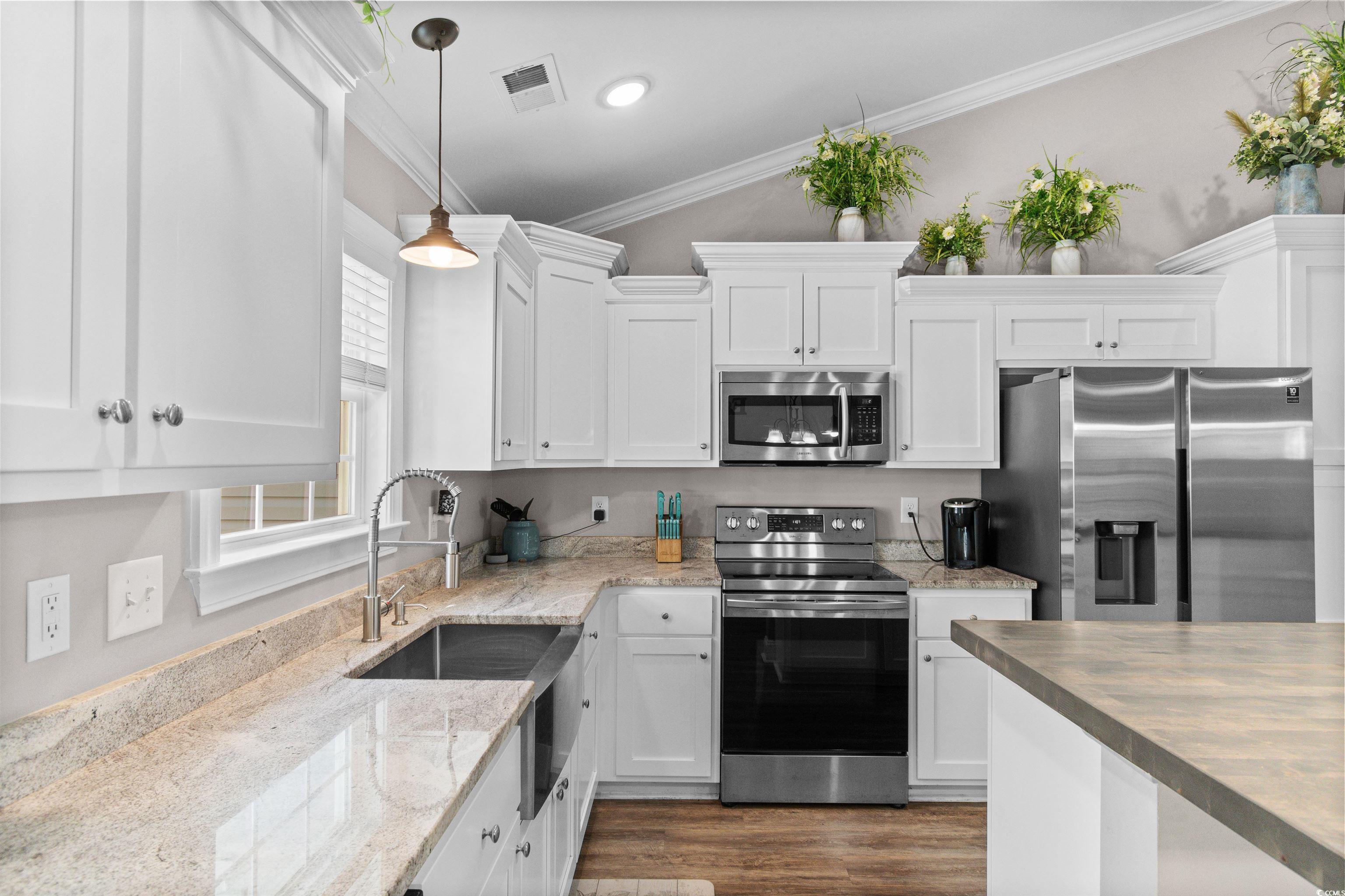 1275 Pinetucky Drive Galivants Ferry, SC 29544 - Photo 6 of 39 Kitchen with appliances with stainless steel finishes, white cabinetry, crown molding, decorative light fixtures, and dark wood-style floors