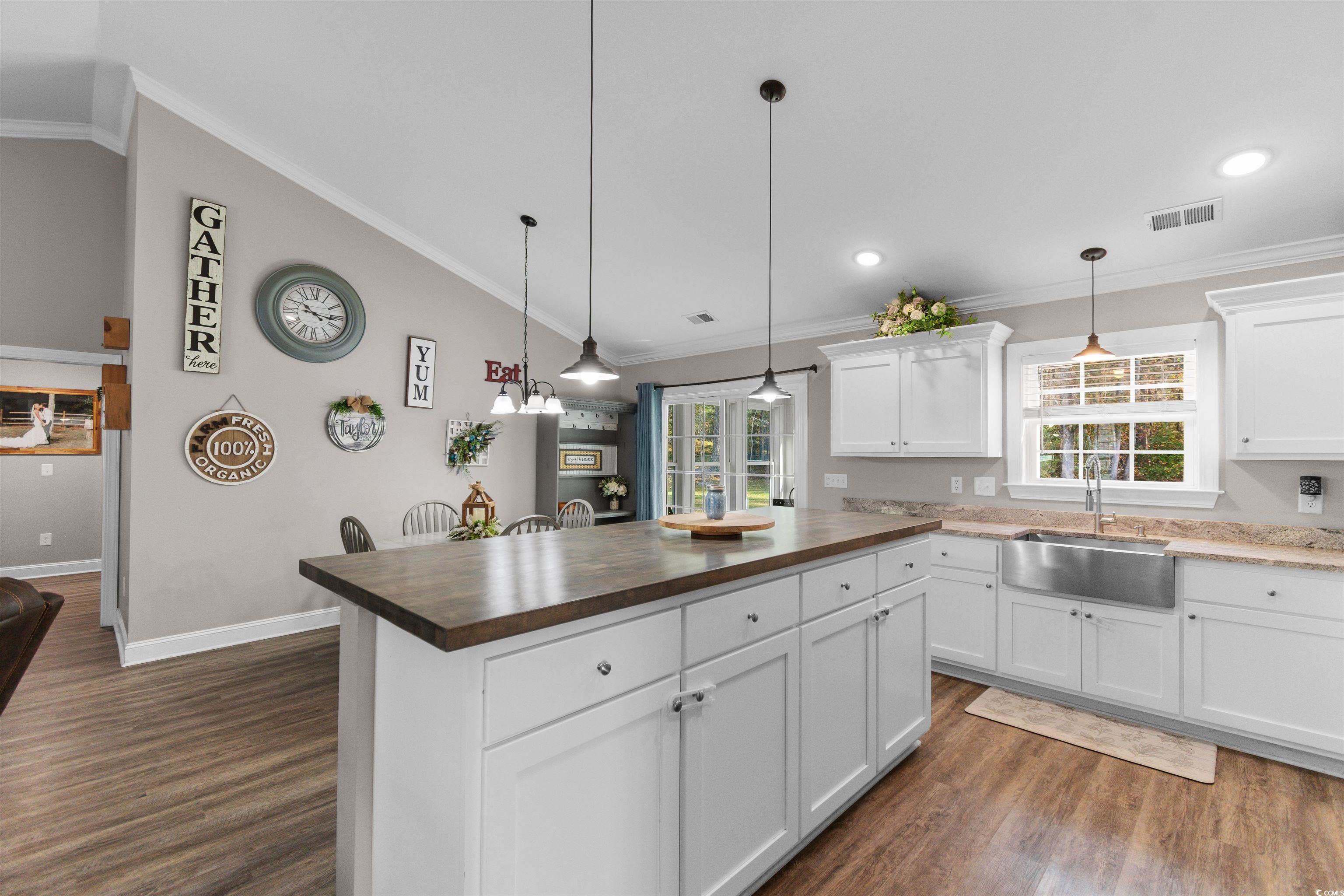 1275 Pinetucky Drive Galivants Ferry, SC 29544 - Photo 10 of 39 Kitchen featuring wooden counters, white cabinetry, crown molding, hanging light fixtures, and vaulted ceiling