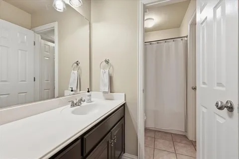 a bathroom with a double vanity sink a mirror and a shower