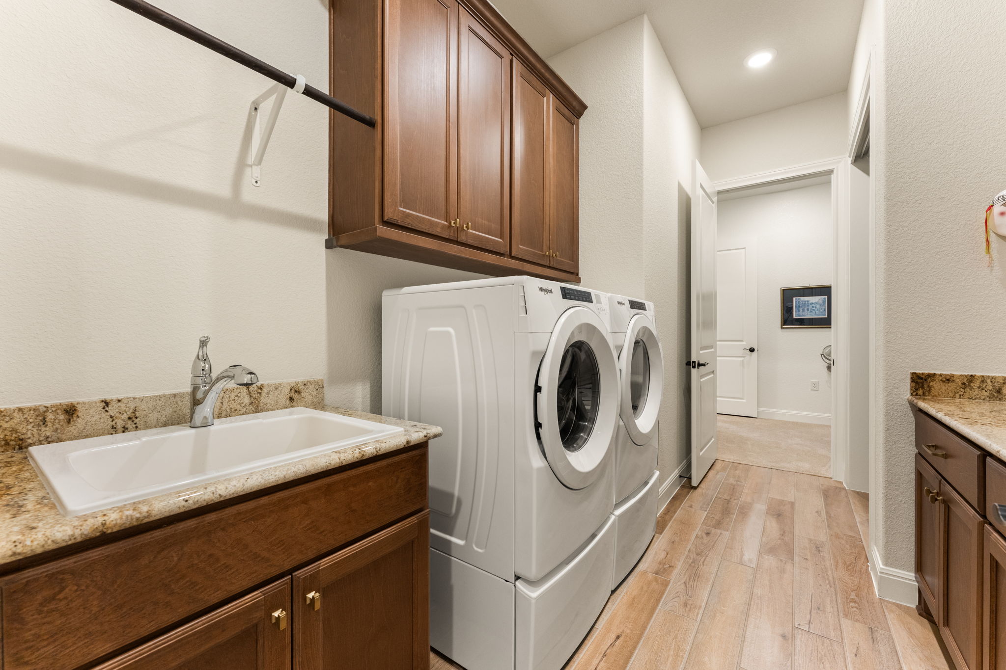 112 Telegraph Lane Georgetown, TX 78633 - Photo 20 of 35 The spacious laundry room features excellent storage and counter space, and offers a sink for convenience. The cabinets are American Beech-Chateau with Crescent Veil countertops.