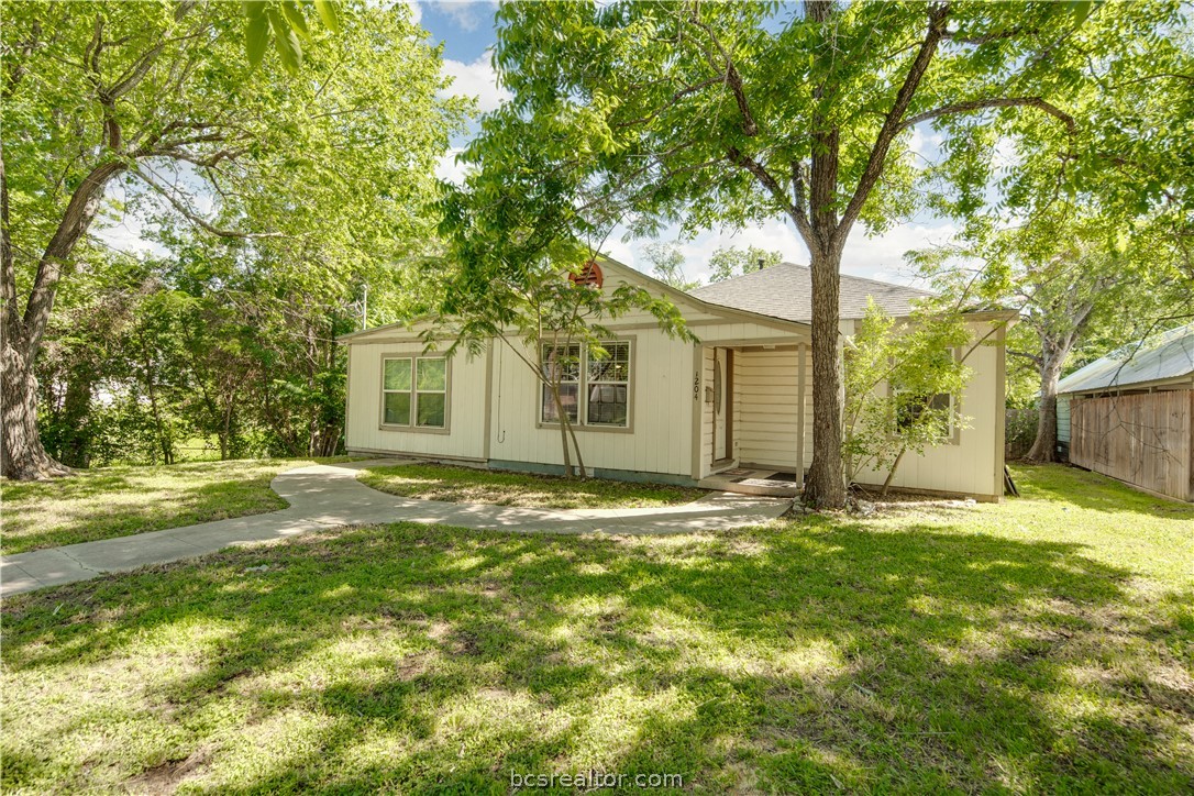 1204 East 28th Street Bryan, TX 77803 - Photo 2 of 22 a backyard of a house with table and chairs
