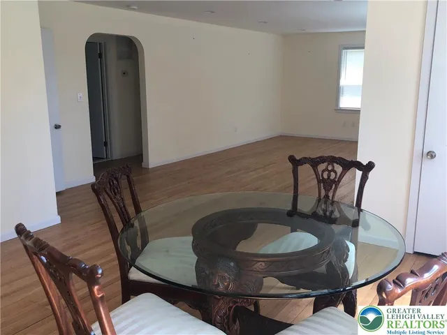a dining room with furniture and wooden floor