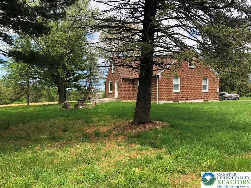 1931 Meadows Road Hellertown, PA 18055 - Photo 4 of 20 a front view of a house with yard and green space