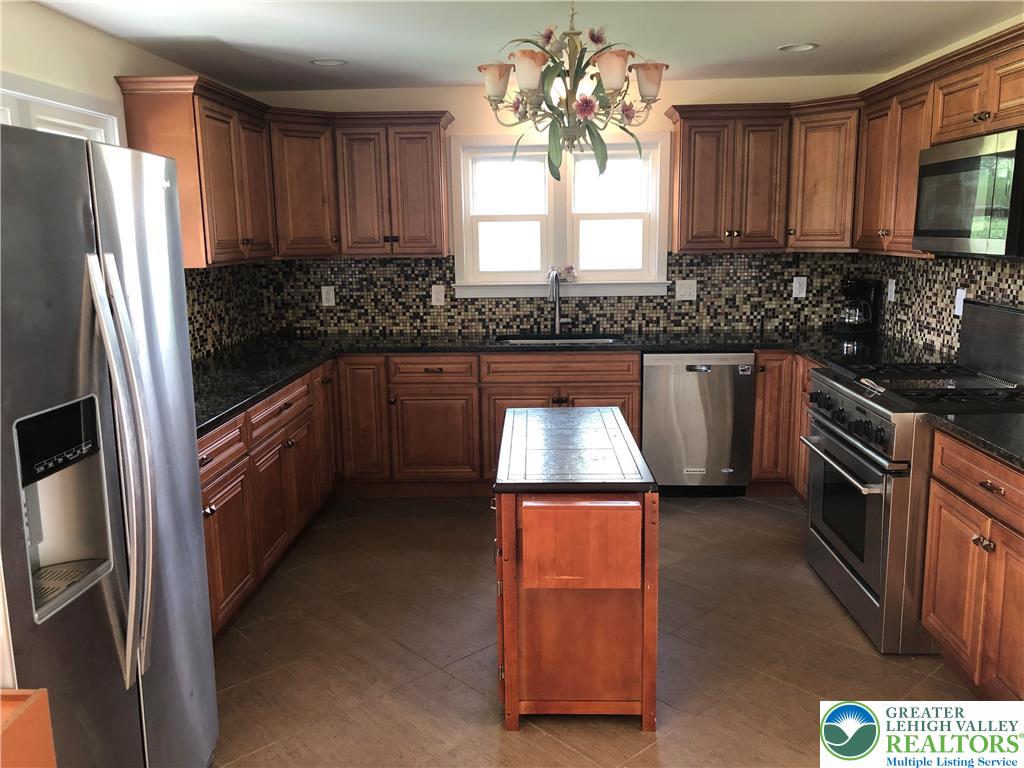 1931 Meadows Road Hellertown, PA 18055 - Photo 7 of 20 a kitchen with granite countertop a sink stainless steel appliances and cabinets