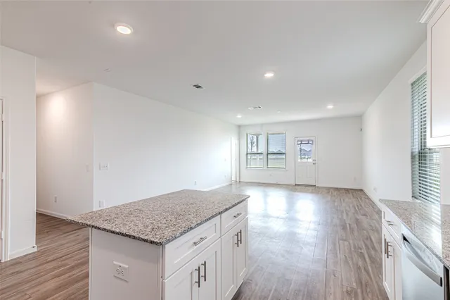 a view of kitchen and hall with wooden floor