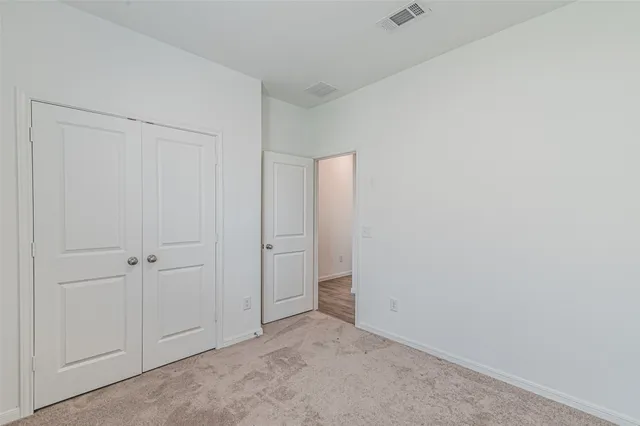 a view of house with backyard and glass windows