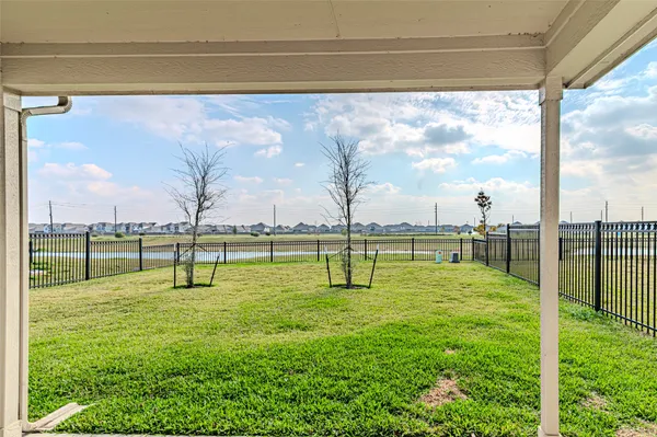 a view of a house with backyard and a tree
