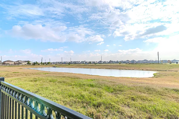 a view of a house with a big yard and large trees
