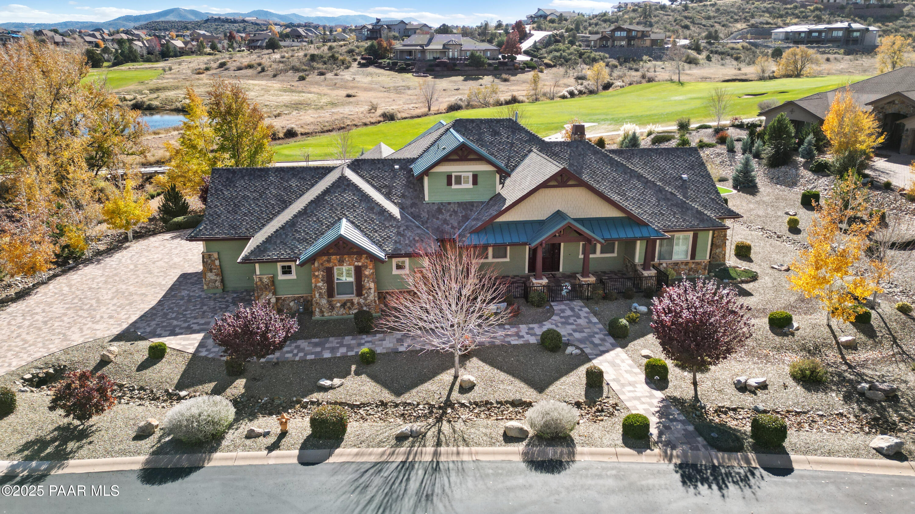 an aerial view of a house with a swimming pool patio and mountain view