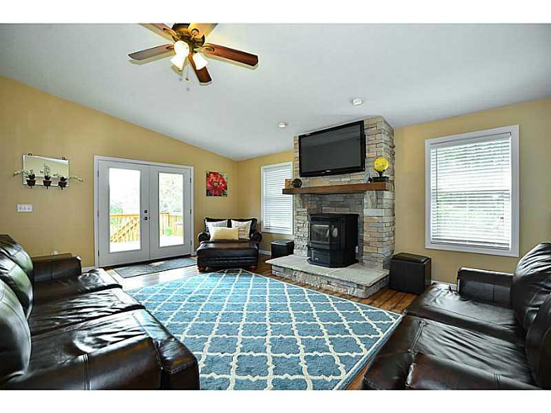 932 Mcelhaney Road Freedom, PA 15042 - Photo 6 of 25 Living Room. 15x22 Living room with drystack stone, reclaimed barn beam mantle, and pellet stove