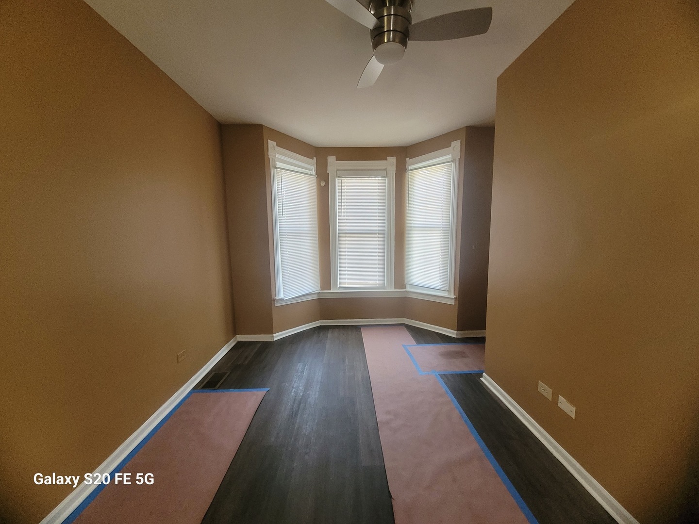 6953 South Loomis Boulevard Chicago, IL 60636 - Photo 3 of 13 an empty room with wooden floor and windows
