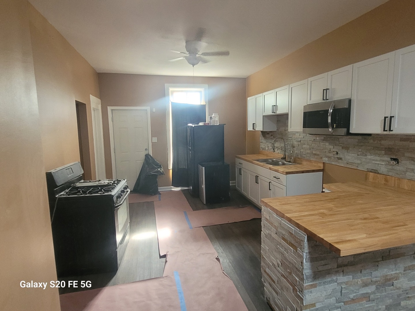 6953 South Loomis Boulevard Chicago, IL 60636 - Photo 7 of 13 a kitchen with stainless steel appliances granite countertop a sink a stove and a refrigerator