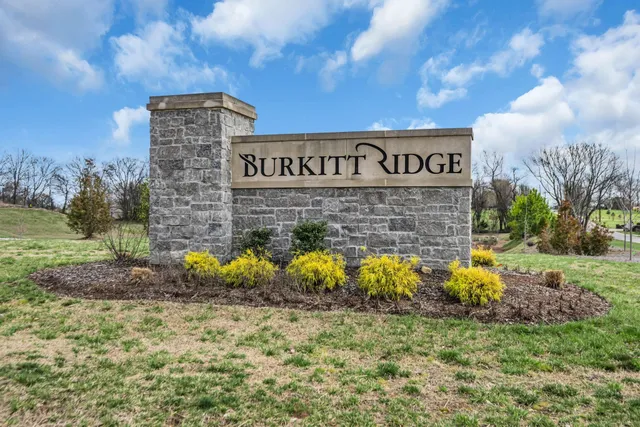 a sign that is in front of a brick building