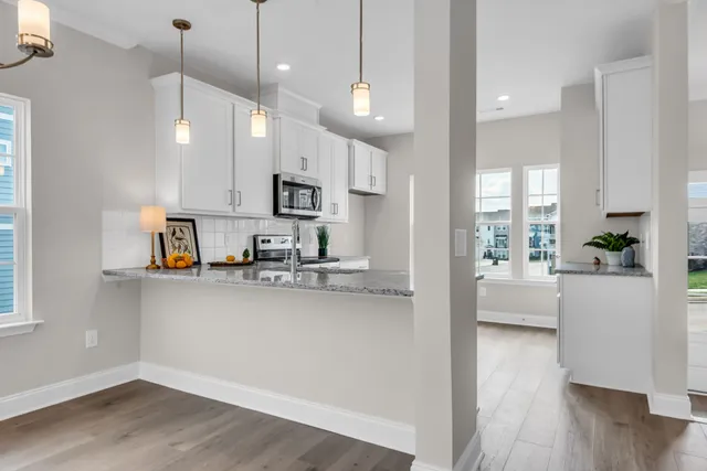 a view of kitchen with sink and wooden floor