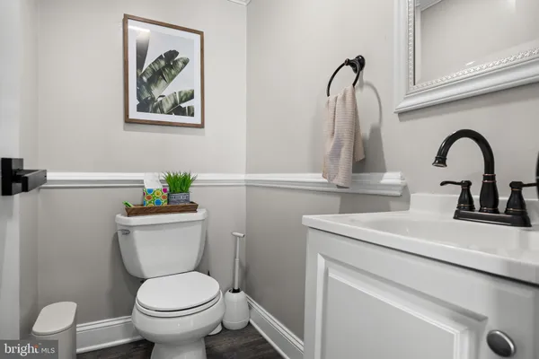 a bathroom with a toilet sink and vanity