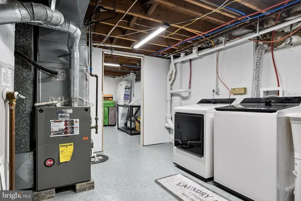 a view of a storage room with fridge and windows