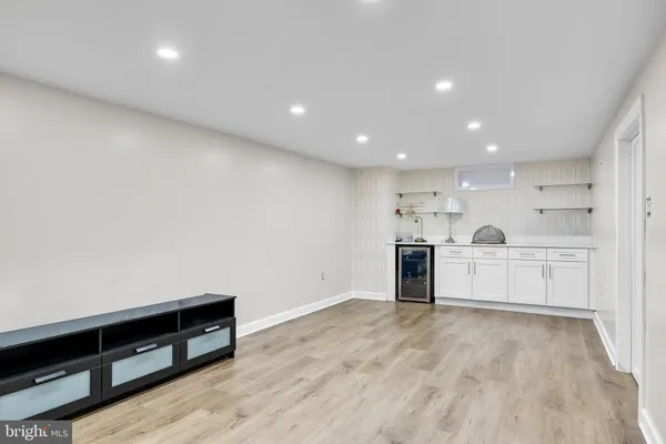 a view of a kitchen with a sink and a refrigerator