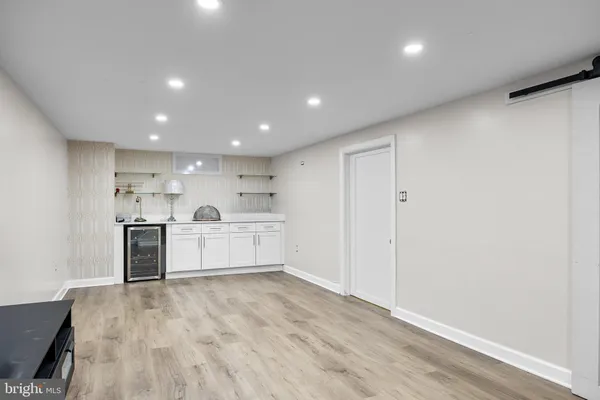 a view of a kitchen with a sink stainless steel appliances and cabinets