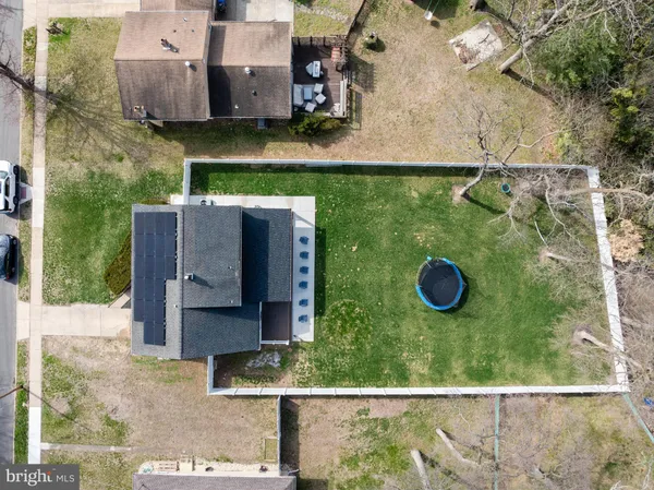 an aerial view of a house with yard