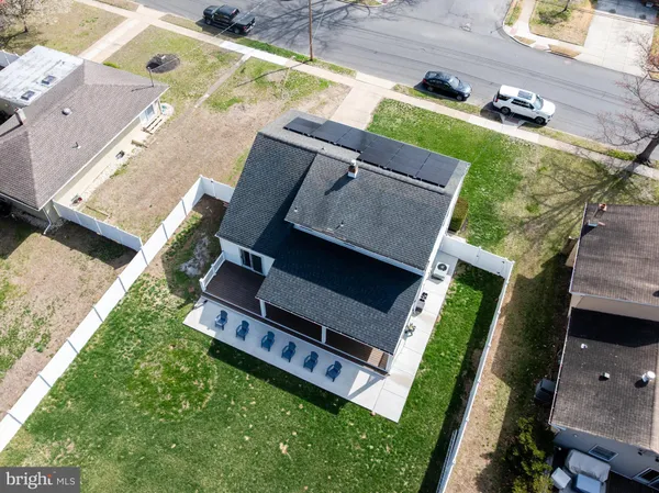 an aerial view of house with backyard space and balcony