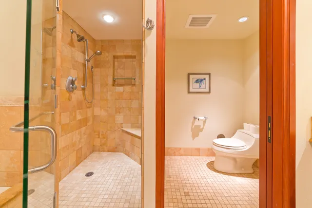 a bathroom with a granite countertop toilet sink and shower