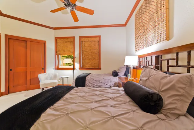 a bedroom with a bed window and wall painting