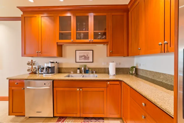 a kitchen with a sink cabinets and a wooden floor