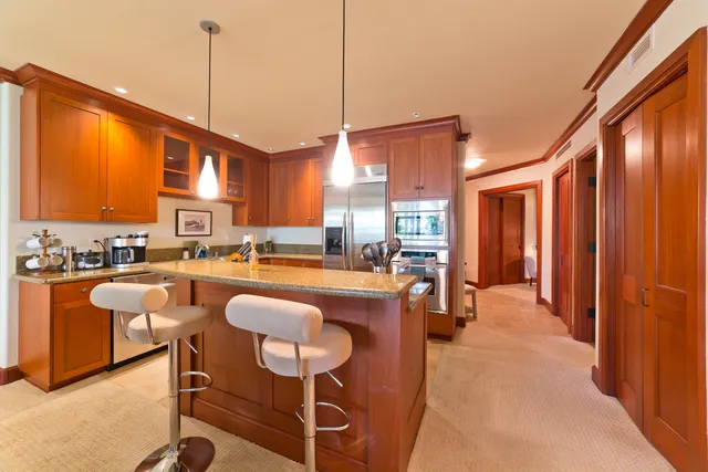 a dining table chairs kitchen view and a large window