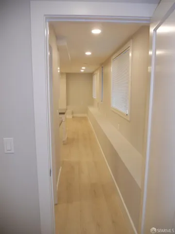 a view of a hallway with wooden floor