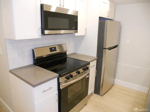 a kitchen with a stove and a microwave