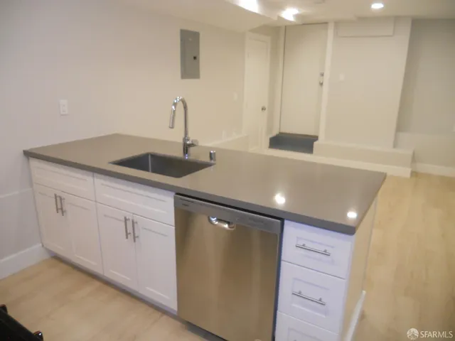 a kitchen with a sink and cabinets