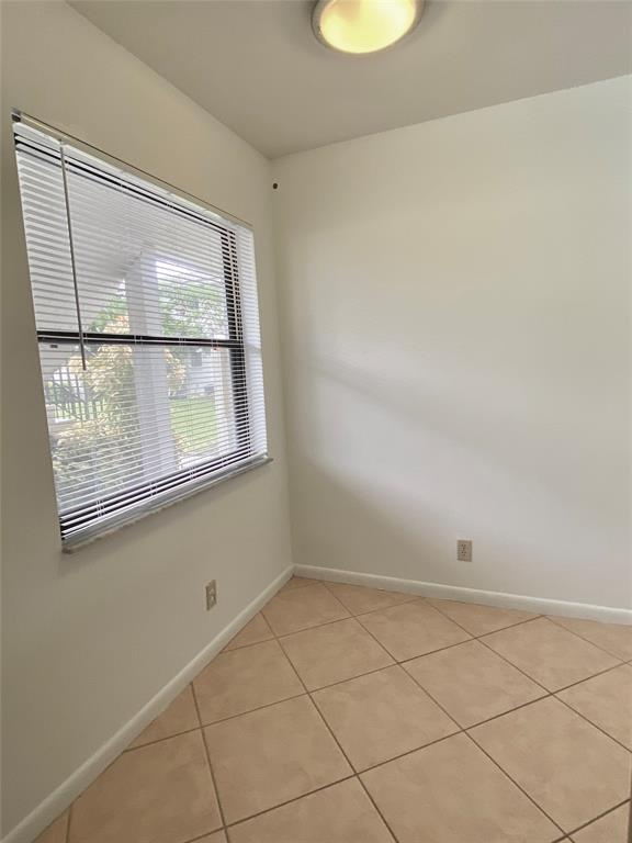 3122 Southwest 20th Terrace, Unit 25B1 Delray Beach, FL 33445 - Photo 8 of 21 a view of an empty room with a window