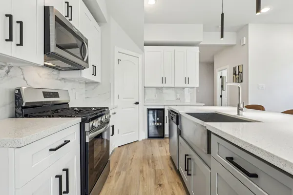 a kitchen with stainless steel appliances granite countertop a stove and a sink