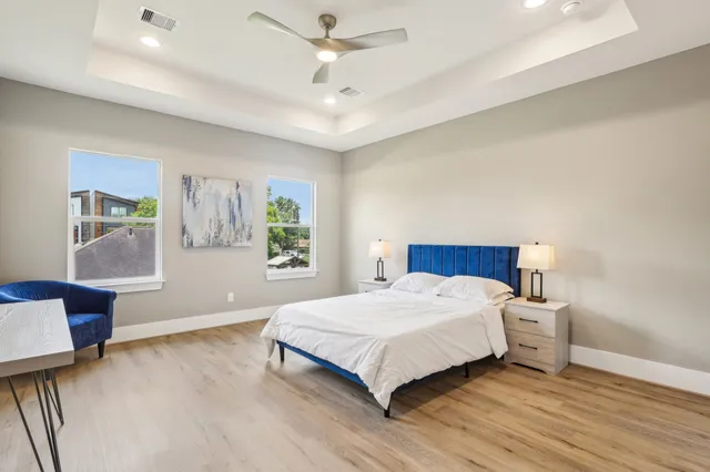 a bedroom with a bed and wooden floor