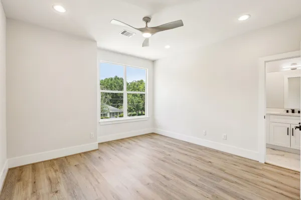 a view of an empty room with wooden floor