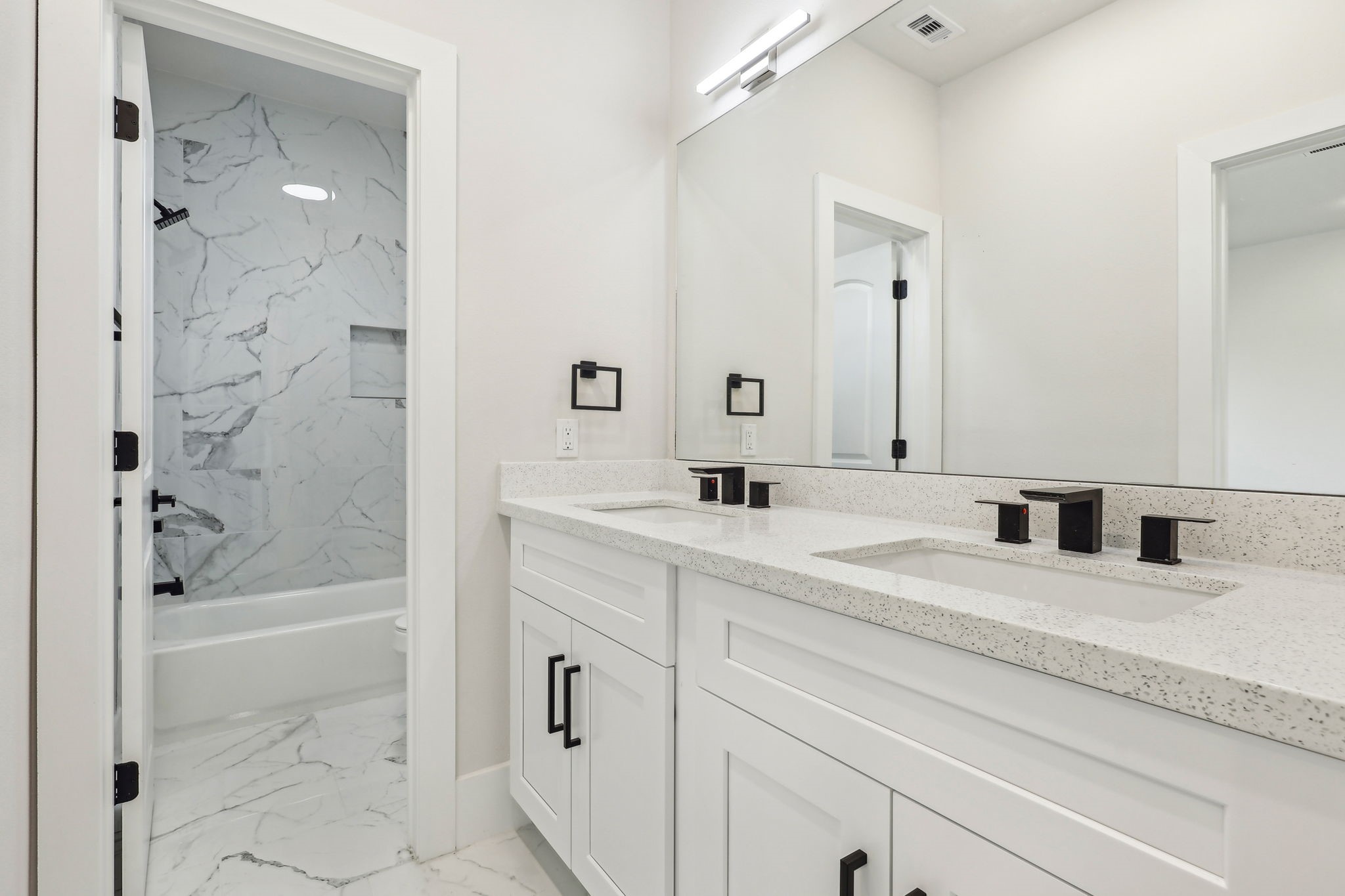 3722 Nathaniel Brown Street Houston, TX 77021 - Photo 27 of 30 a bathroom with a granite countertop sink a mirror a bathtub and shower