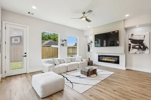 a living room with furniture a fireplace and a flat screen tv