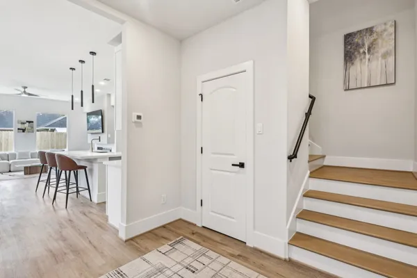 a view of a hallway with furniture and entryway